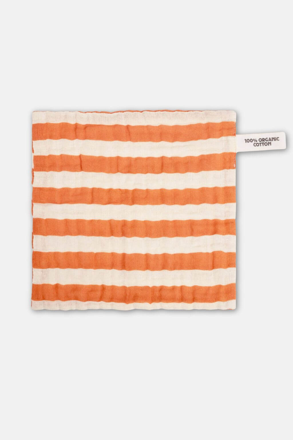 flat lay of orange striped organic cotton washcloth with textured cotton weave