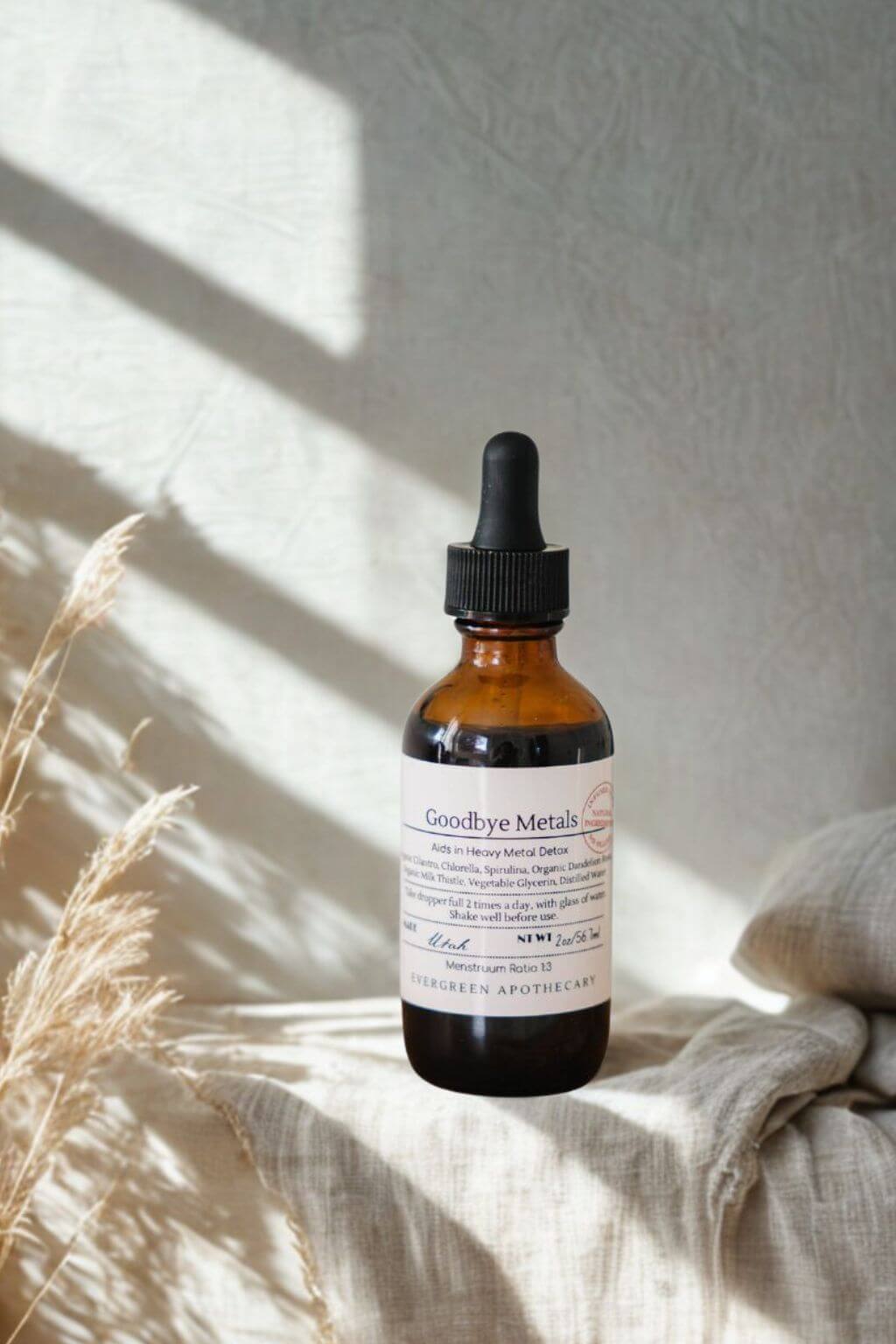 evergreen apothecary goodbye metals detox tincture with linen and natural sunlight