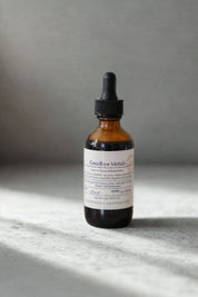 evergreen apothecary goodbye metals herbal tincture in amber dropper bottle