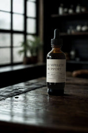 evergreen apothecary lymphatic support tincture bottle on wooden table in apothecary setting