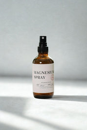 evergreen apothecary magnesium spray bottle on minimal light background