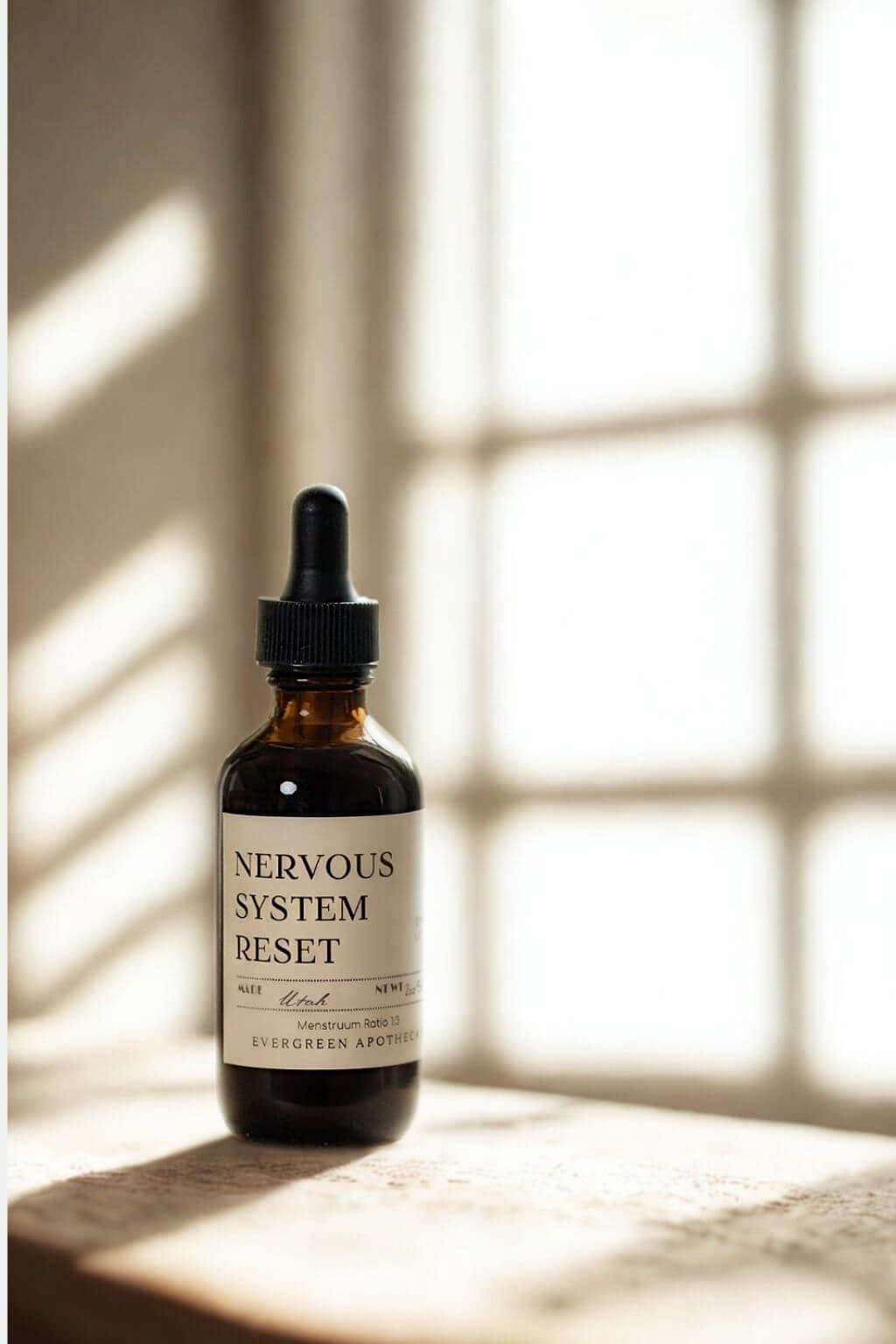 evergreen apothecary nervous system reset herbal tincture in warm window light