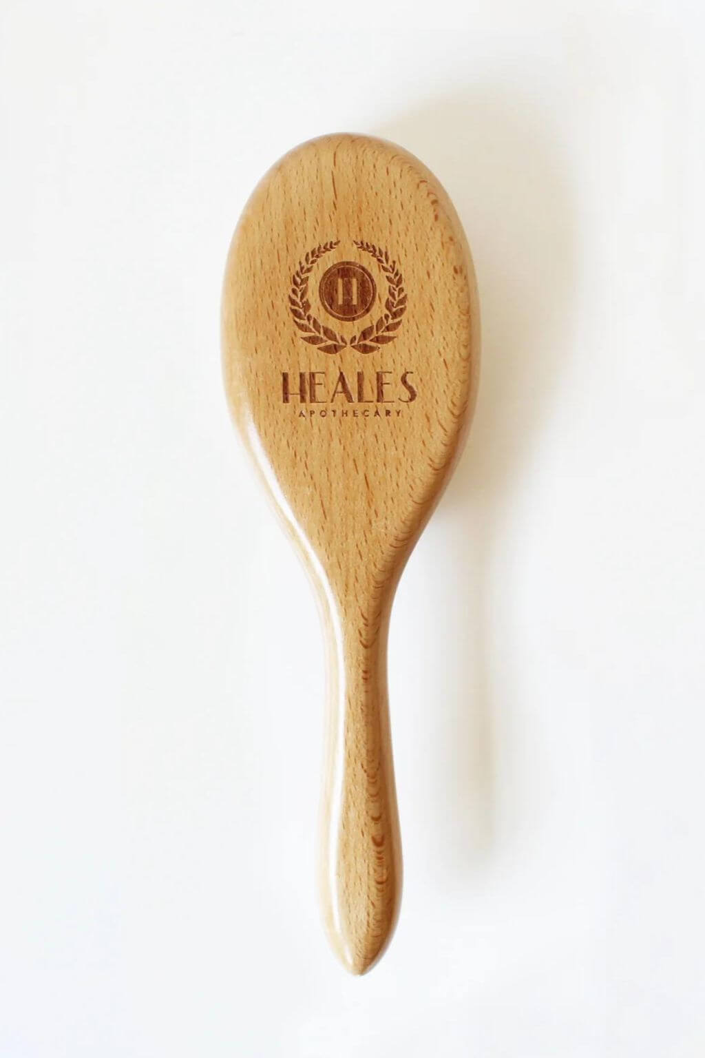Heales vegan dry massage brush with beechwood handle on a white background