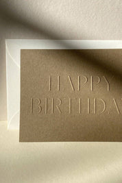 Close-up of blind embossed birthday card showing textured lettering