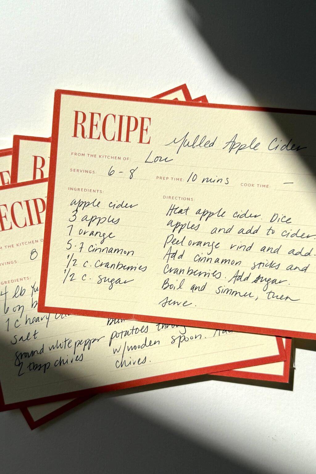 Stack of vintage-inspired recipe cards styled in natural light