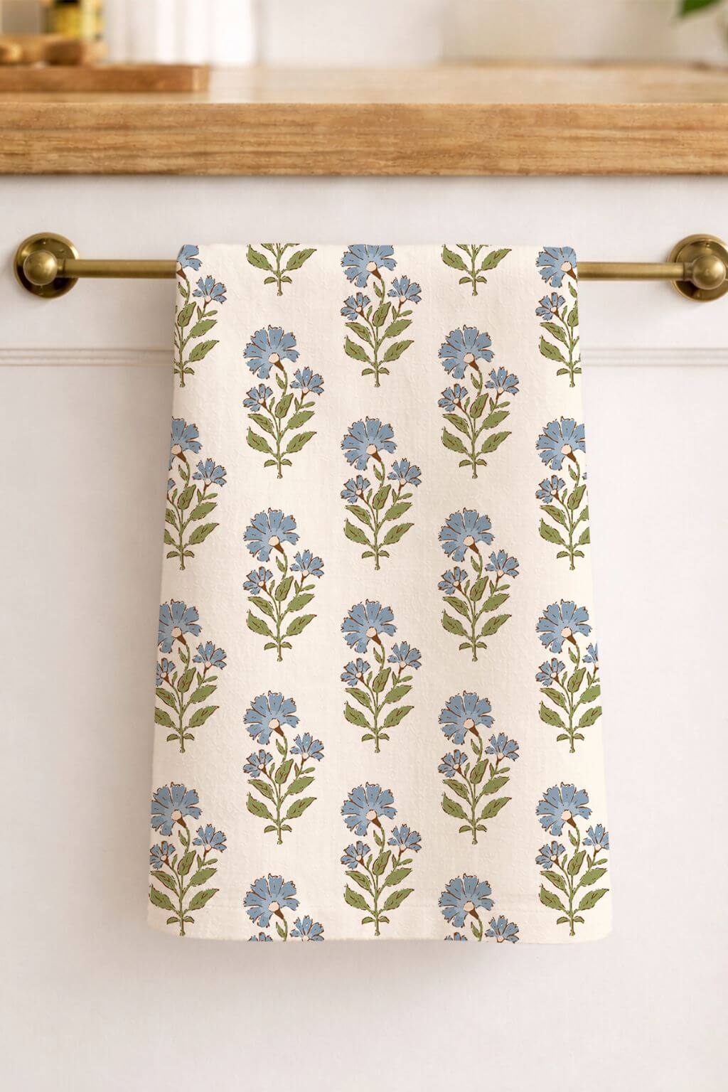 Botanical linen tea towel hanging on brass bar