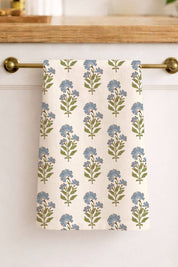 Botanical linen tea towel hanging on brass bar