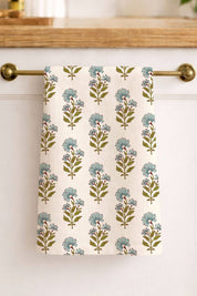 Floral marigold patterned towel hanging on a kitchen cabinet handle.