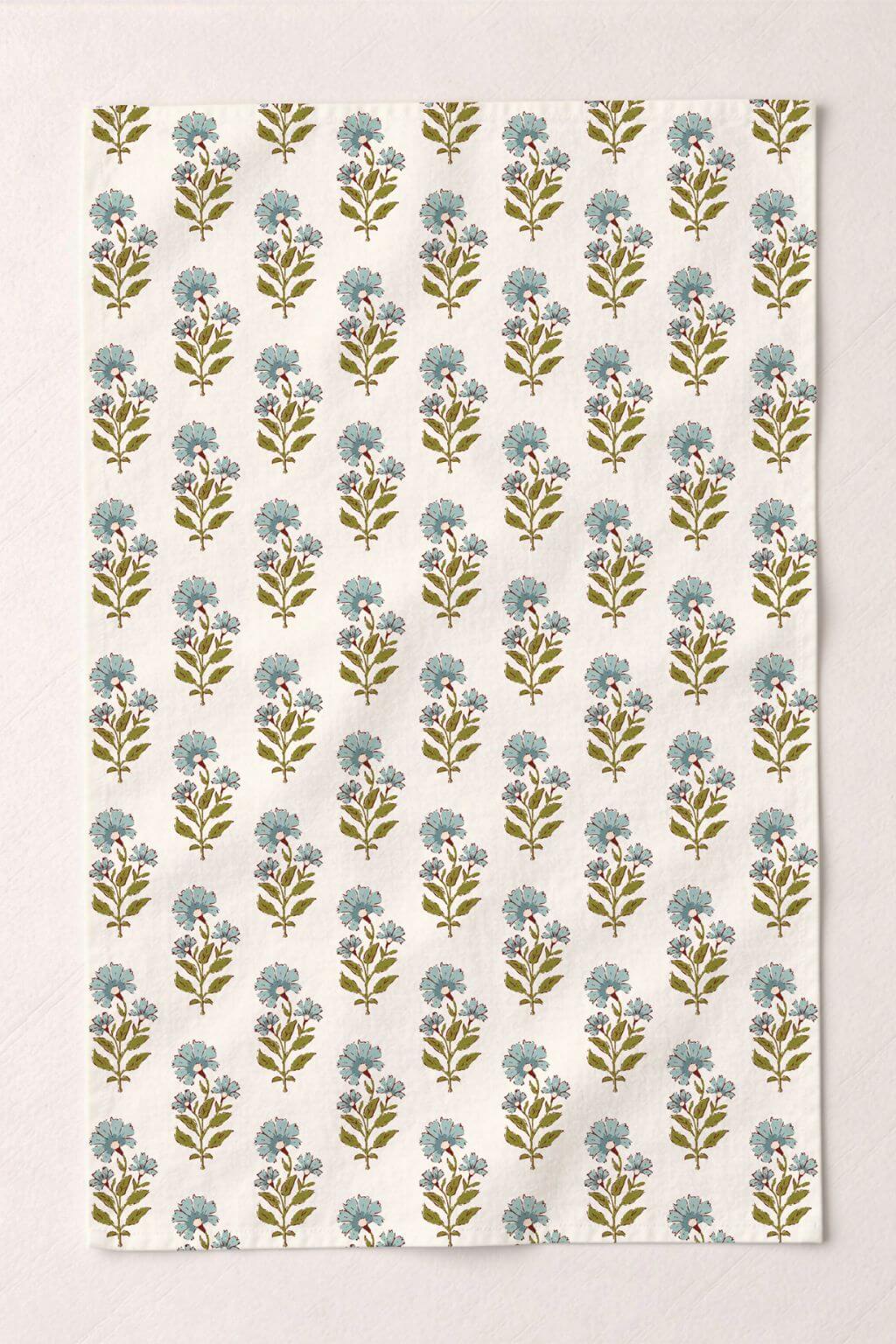Floral patterned kitchen towel with robin's egg blue and green flowers on a beige background