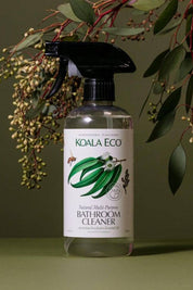 Bottle of Koala Eco Bathroom Cleaner with green leaves and branches in the background