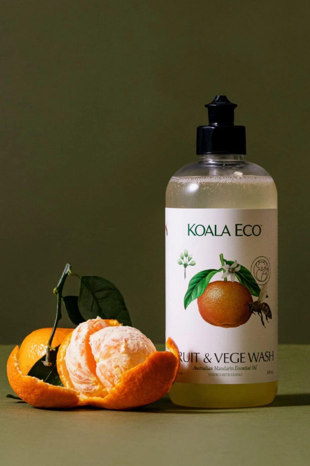 Koala Eco Natural Fruit and Vegetable Wash bottle with an orange on a green background