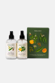 A bottle of Koala Eco Natural Pillow + Linen Spray and Natural Room Spray with a dark green gift box featuring botanical drawings