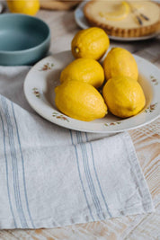 stonewashed linen kitchen towel soft textured stripe styled next to lemons