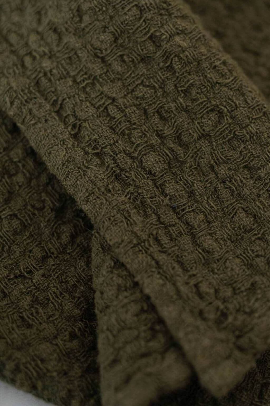 Close-up detail of martini olive linen waffle weave fabric