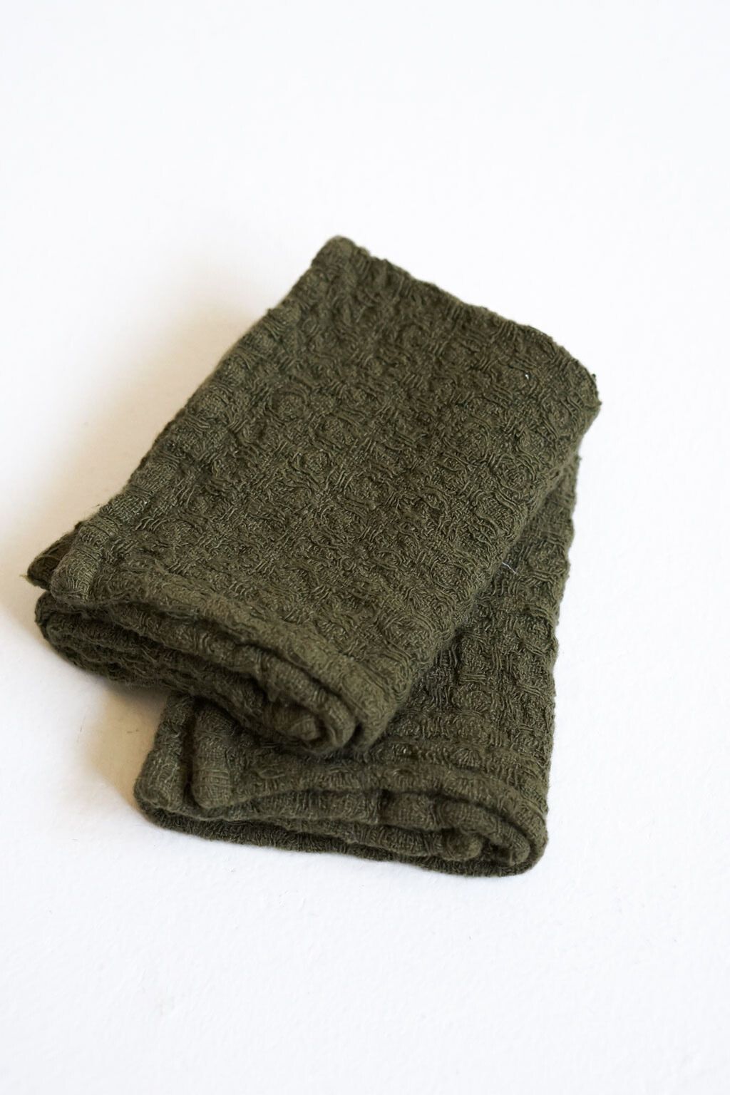 Folded martini olive linen waffle dishcloth showcasing texture and softness