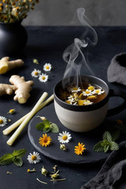Herbal tea infusion of Constellations Within Gut Restoration Tea with floating chamomile flowers, ginger, mint, and calendula