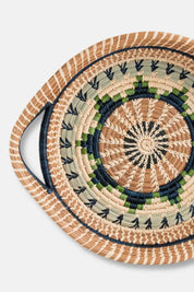 Woven basket with circular design on a light gray background