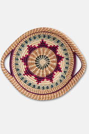 Woven basket with a circular pattern on a light gray background