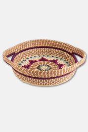 Woven basket with decorative lid on a white background