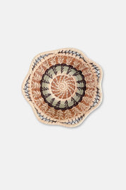 Decorative plate with a spiral pattern on a light gray background