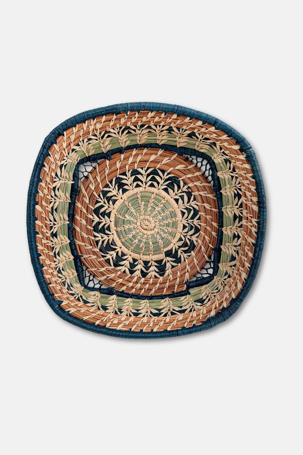 Decorative woven mat with concentric circle pattern on a white background