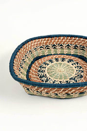 Woven basket with decorative patterns on a white background