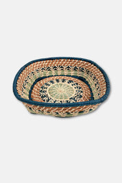 Woven basket with a decorative pattern on a white background