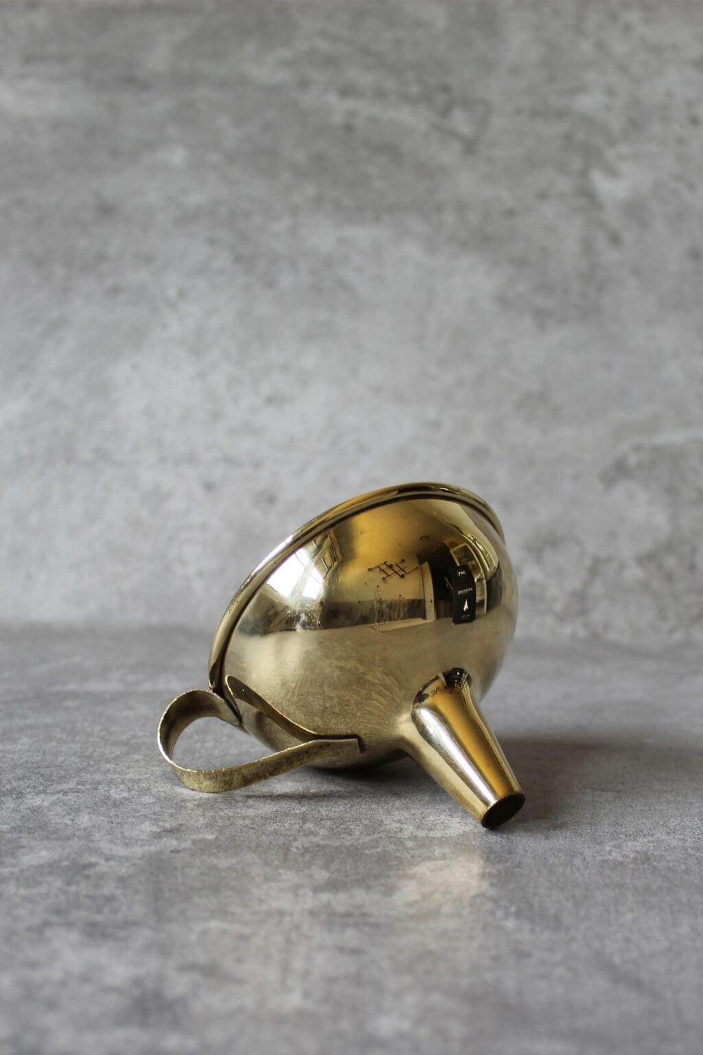 Gold funnel on a gray surface