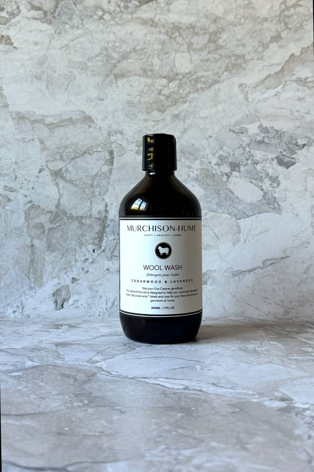 Bottle of Murchison-Hume Wool Wash on a textured gray surface