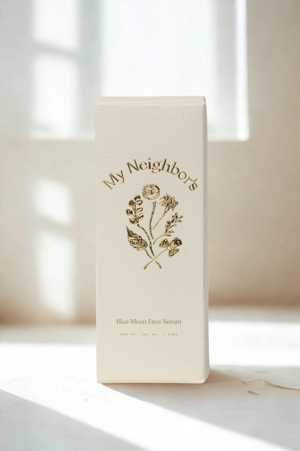 Skincare serum bottle with 'My Neighbor's' branding on a light background