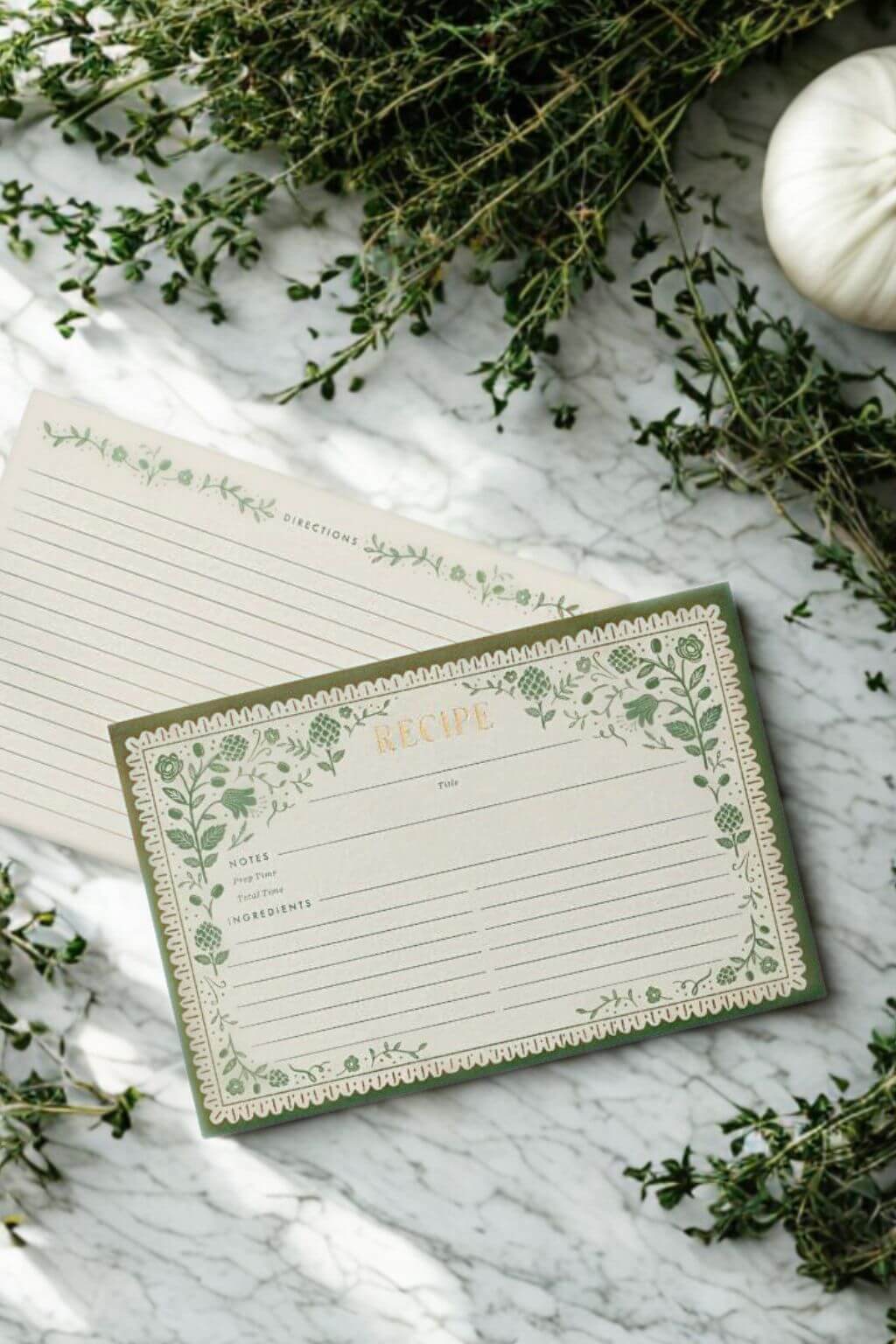 Artichoke Recipe Cards displayed with fresh thyme and marble surface