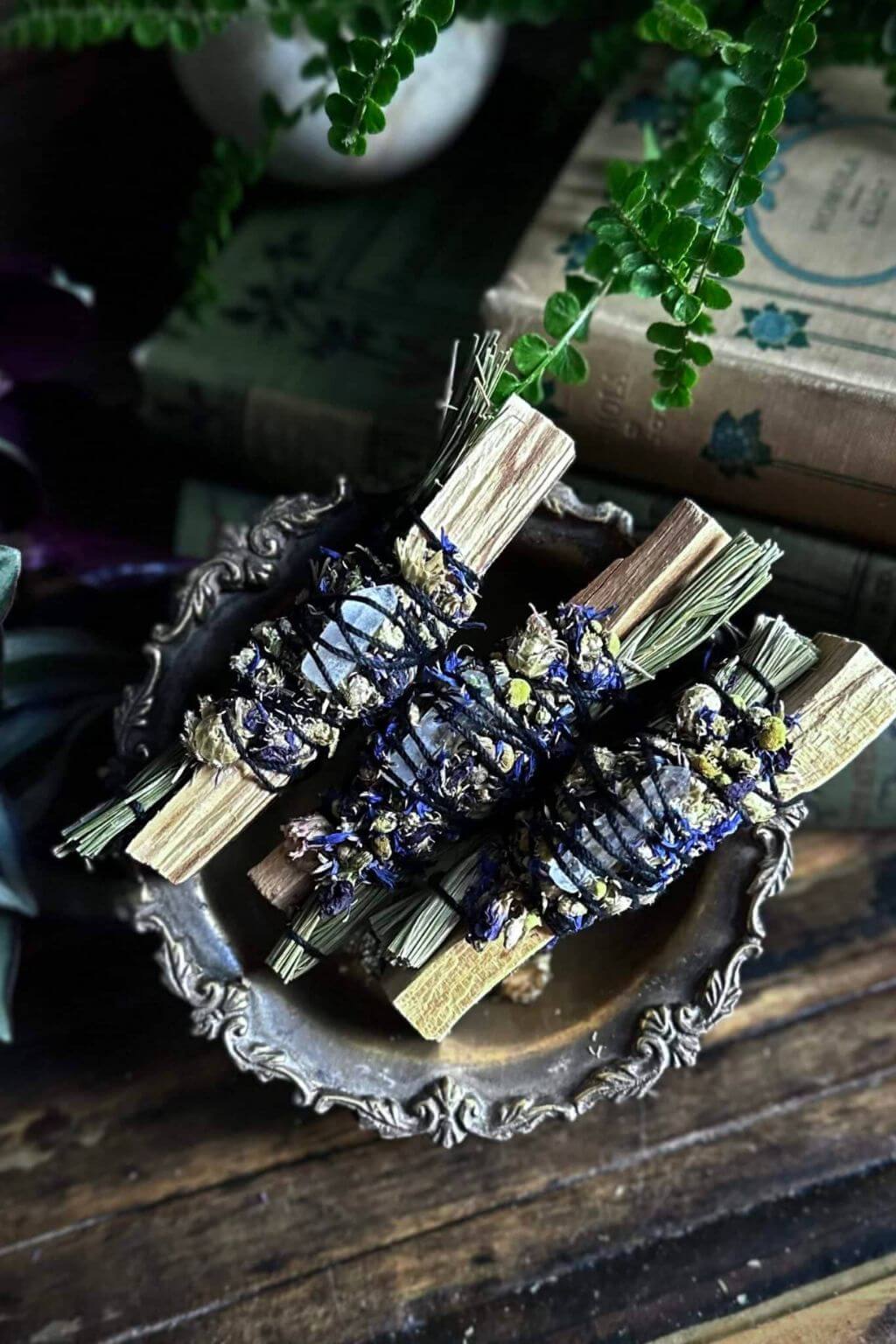 handcrafted sweetgrass and palo santo bundles in decorative tray