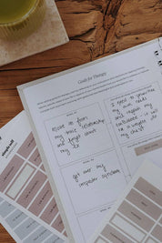 Notebook with therapy goals on a wooden surface