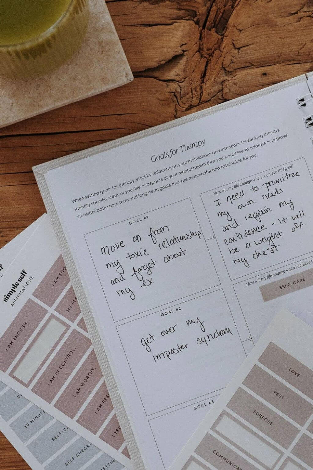 Notebook with therapy goals on a wooden surface