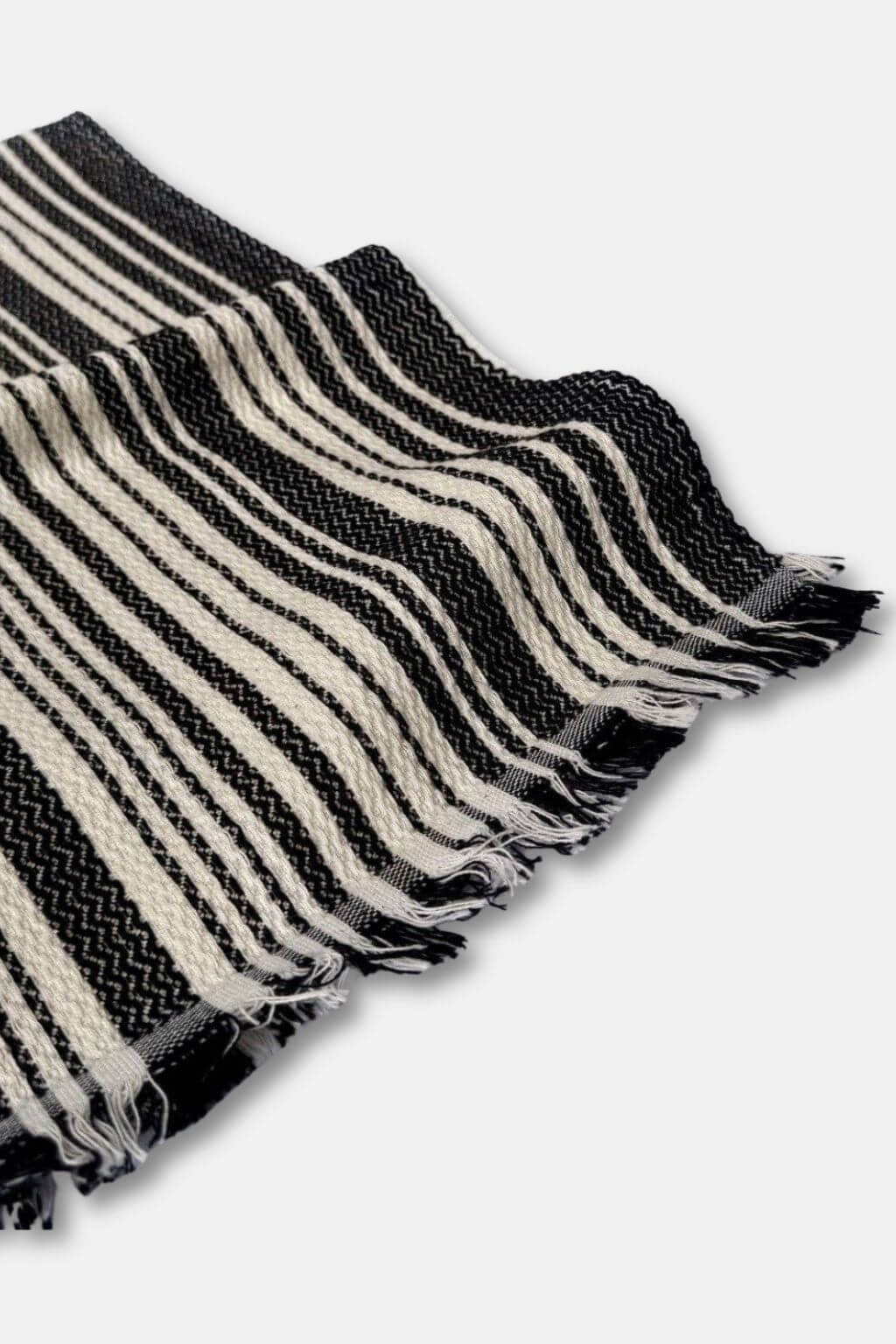 Black and cream striped towel on a white background