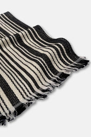 Black and cream striped towel on a white background