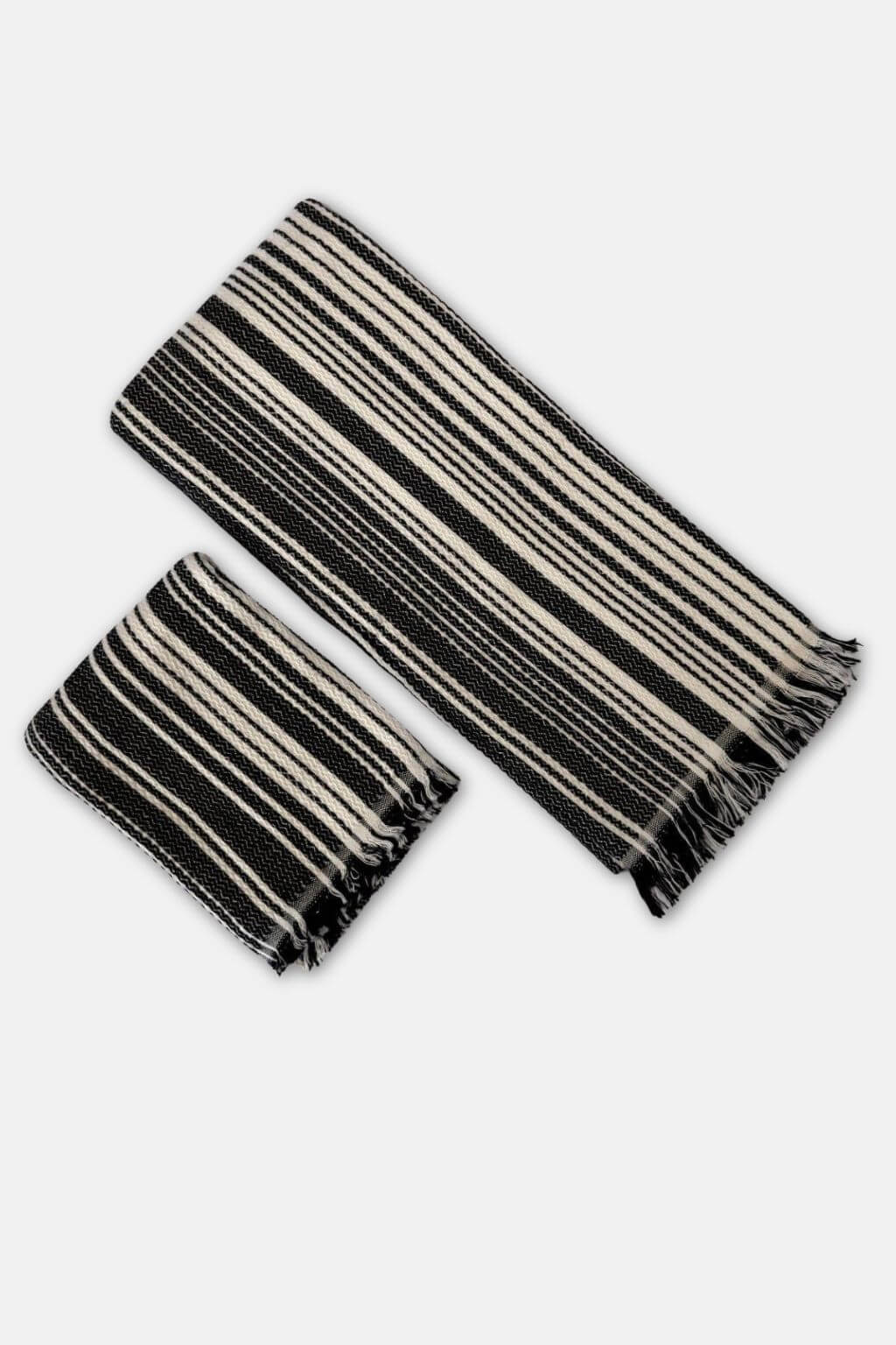 Black and cream striped towels on a white background