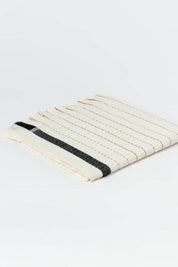 Textured woven hand towel with black stripe on a white background
