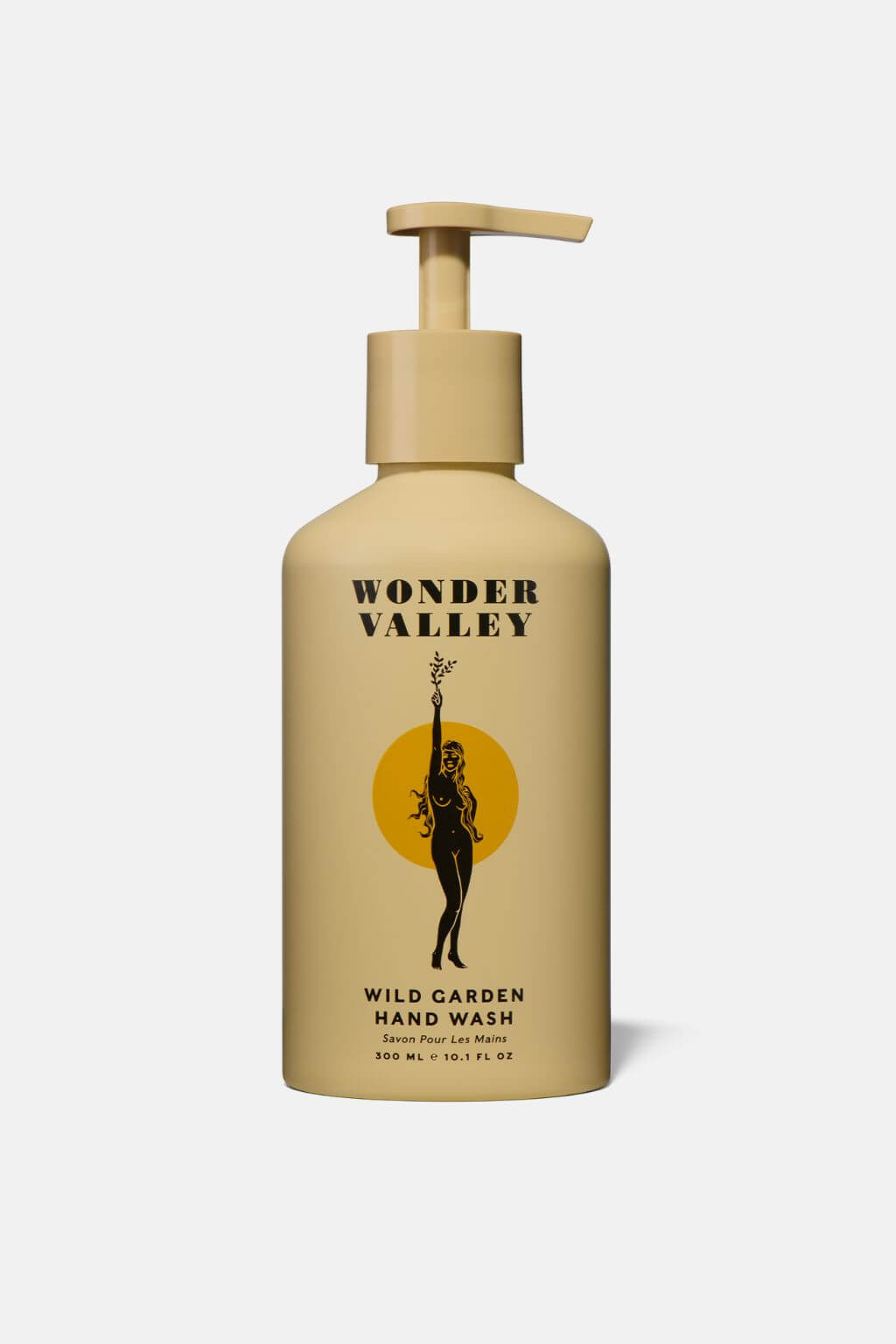 Wonder Valley Wild Garden Hand Wash in a beige pump bottle with a black and yellow graphic label, shown against a light gray background.