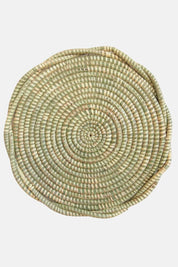 Round handwoven sweetgrass trivet with spiral pattern in natural green and straw tones