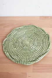 Twisted sweetgrass trivet with layered spiral weave in soft sage green tones