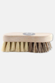 Side view of dual-bristle vegetable brush, combining soft and stiff fibers for effective, eco-friendly cleaning