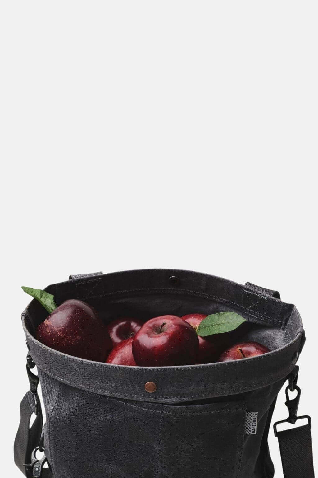 Waxed canvas harvest bag carrying apples