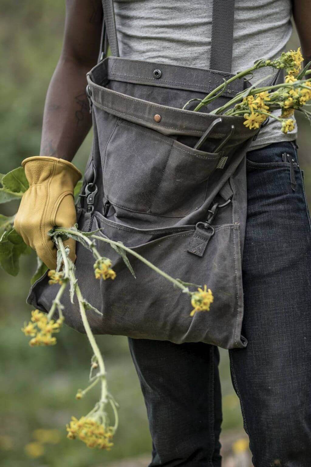 Waxed canvas foraging bag filled with greenery