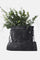 Waxed canvas foraging bag filled with greenery