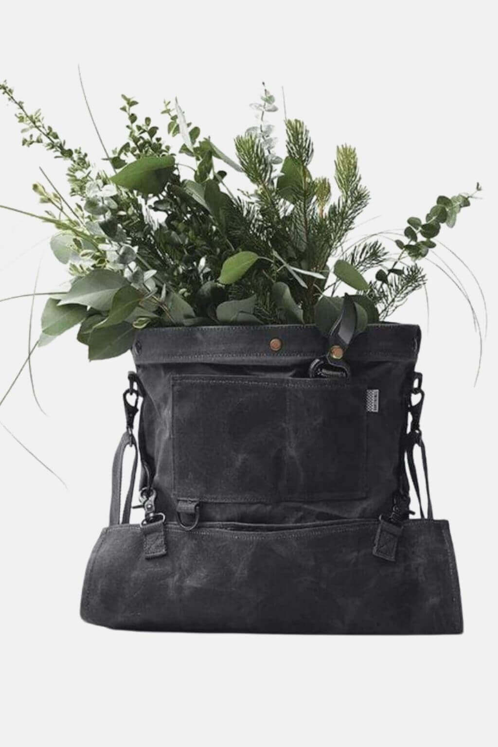 Waxed canvas foraging bag filled with greenery