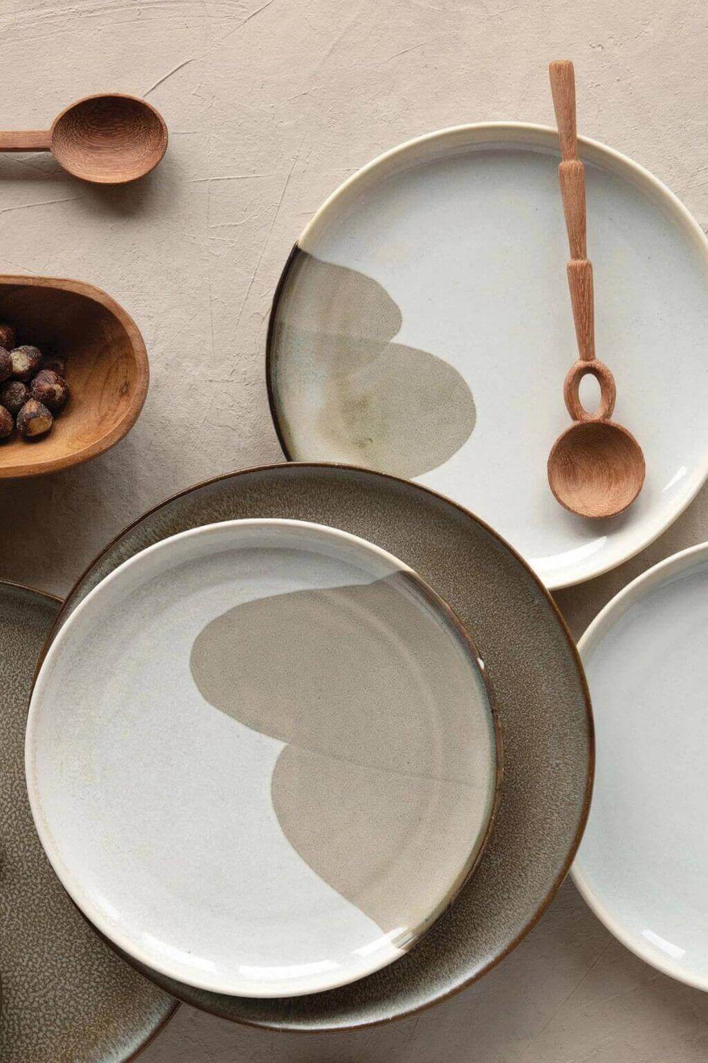 Artisan doussie wood spoon on ceramic plate