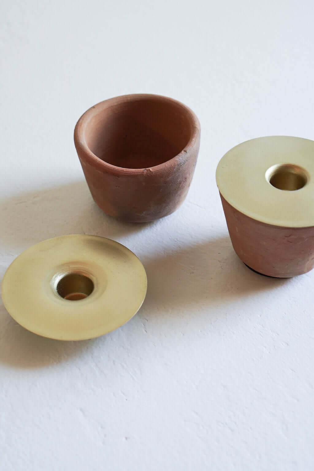 terracotta candle holder and brass candle insert detail