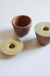 terracotta candle holder and brass candle insert detail