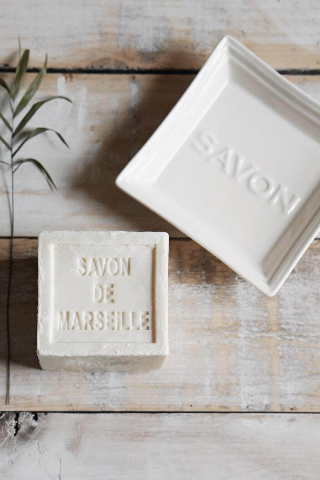 Square ceramic Savon soap tray beside handcrafted soap